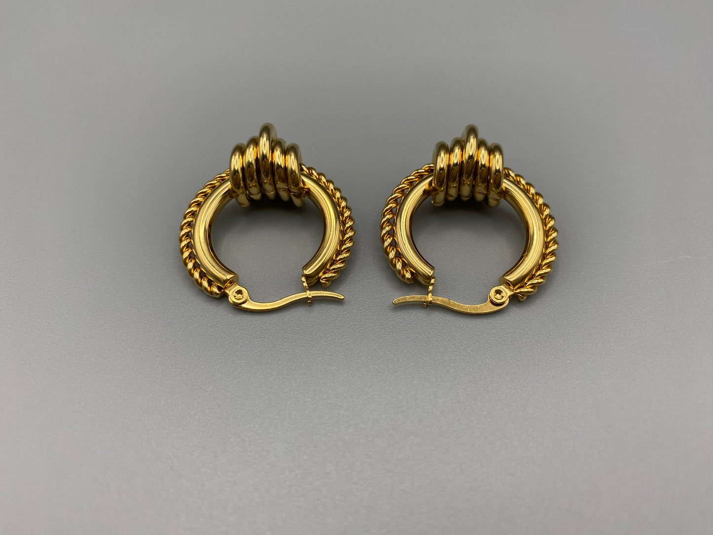 “Vespera Gold Earrings: A perfect blend of elegance and modernity, crafted from hypoallergenic 316L stainless steel and plated with luxurious 18K gold. Durable and high-quality, ideal for sensitive ears and long-lasting shine.”