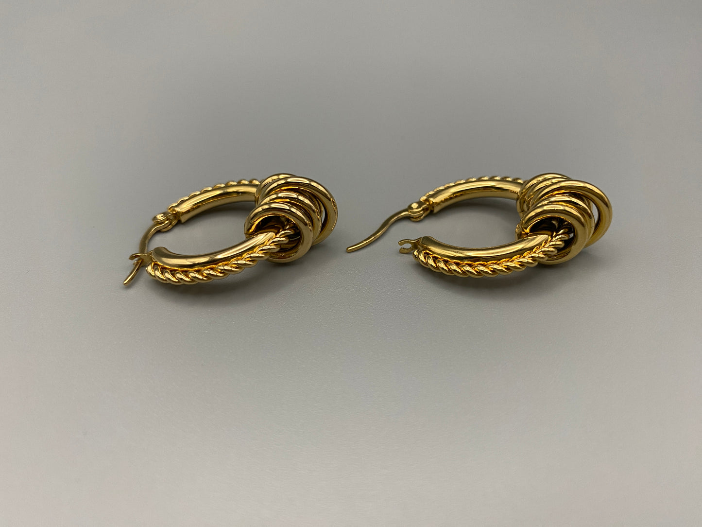 “Vespera Gold Earrings: A perfect blend of elegance and modernity, crafted from hypoallergenic 316L stainless steel and plated with luxurious 18K gold. Durable and high-quality, ideal for sensitive ears and long-lasting shine.”