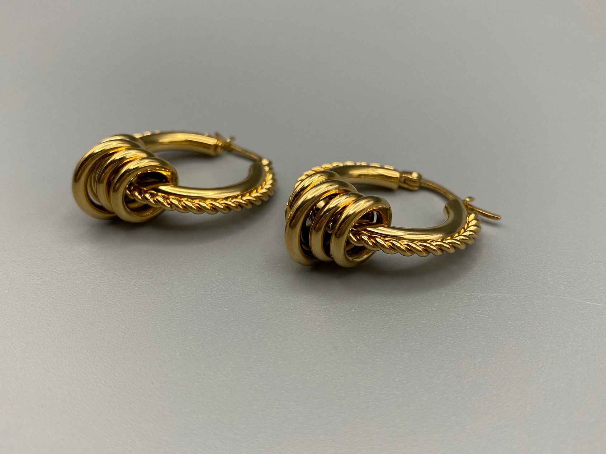 “Vespera Gold Earrings: A perfect blend of elegance and modernity, crafted from hypoallergenic 316L stainless steel and plated with luxurious 18K gold. Durable and high-quality, ideal for sensitive ears and long-lasting shine.”