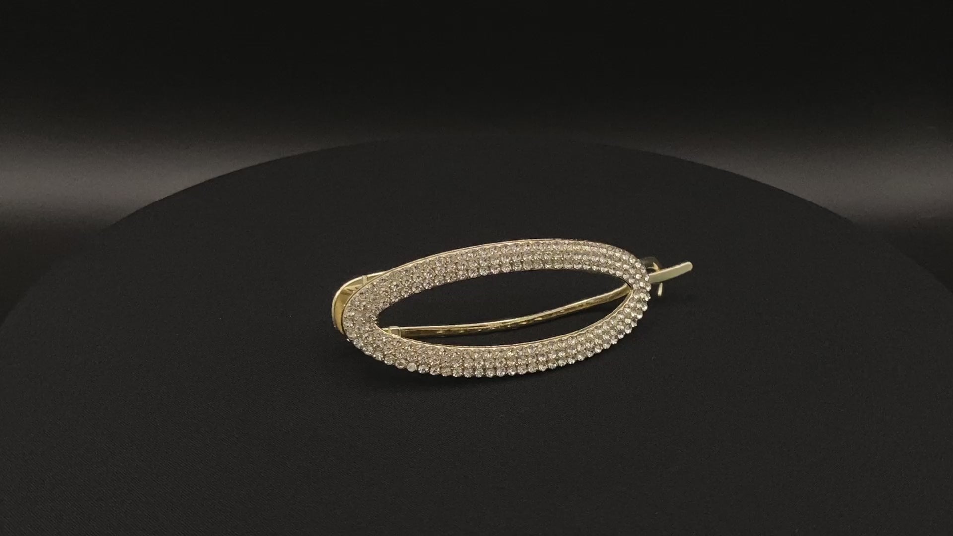 “GlitzGrip Hollow Gold Hair Clip featuring a hollow oval design with sparkling zircon gems, measuring 9.5 cm in length. Elegant and durable, perfect for various hairstyles.”