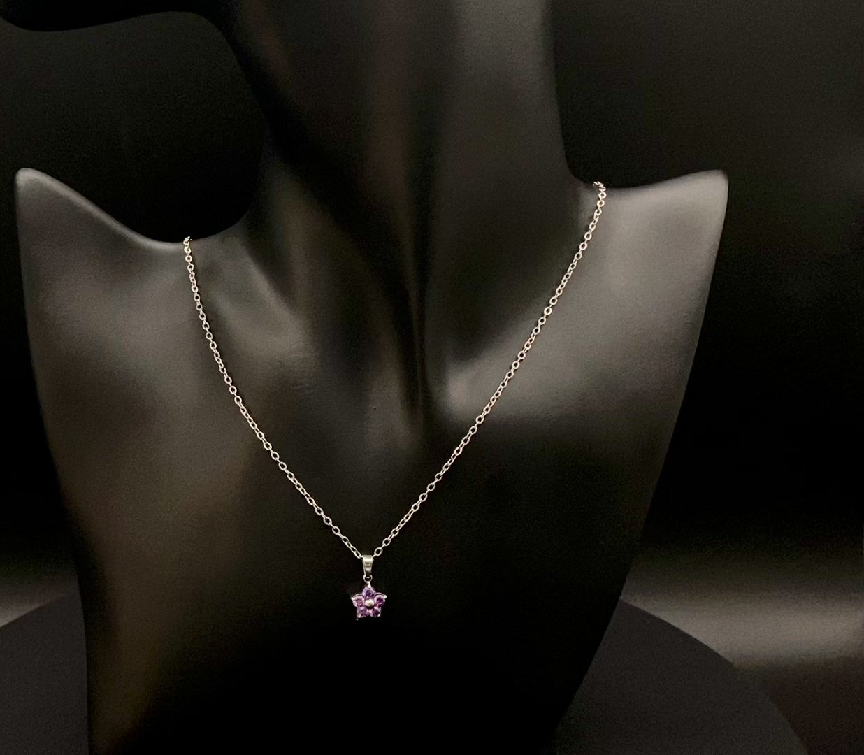 “Blossom Silver Pendant Necklace with a plum blossom design, featuring colourful cubic zirconia stones in a claw setting. Made from durable stainless steel with PVD plating. Measures 46 cm with a 5 cm adjustment.”