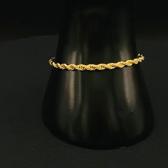 “Spiral Splendor Bracelet in gold with an intricate spiral design, featuring luxurious gold plating and PVD plating for durability. Made from stainless steel, adjustable length of 17.5 cm with a 3 cm extension.”