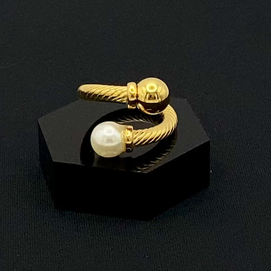 Twisted Elegance Pearl and Gold Ring: Features 18k PVD gold plating for a luxurious and durable finish. The twisted design adds a unique and elegant touch, while the pearl inlay is securely set in a claw setting. This ring is nickel-free and lead-free, making it safe for sensitive skin. It is also waterproof and non-tarnish, ensuring long-lasting beauty and wearability. Available in size 6 for a comfortable fit. Perfect for those who seek both style and substance in their jewellery.