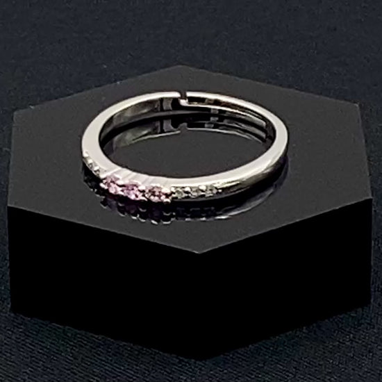 Tanvi Pink Ring: This stunning piece features alternating brilliant blue and clear cubic zirconia stones, set in a sleek silver-plated band. The adjustable fit ensures comfort for any finger size. The ring is non-tarnish and waterproof, maintaining its shine over time. Perfect for everyday wear, the Tanvi ring is your go-to accessory for timeless beauty.