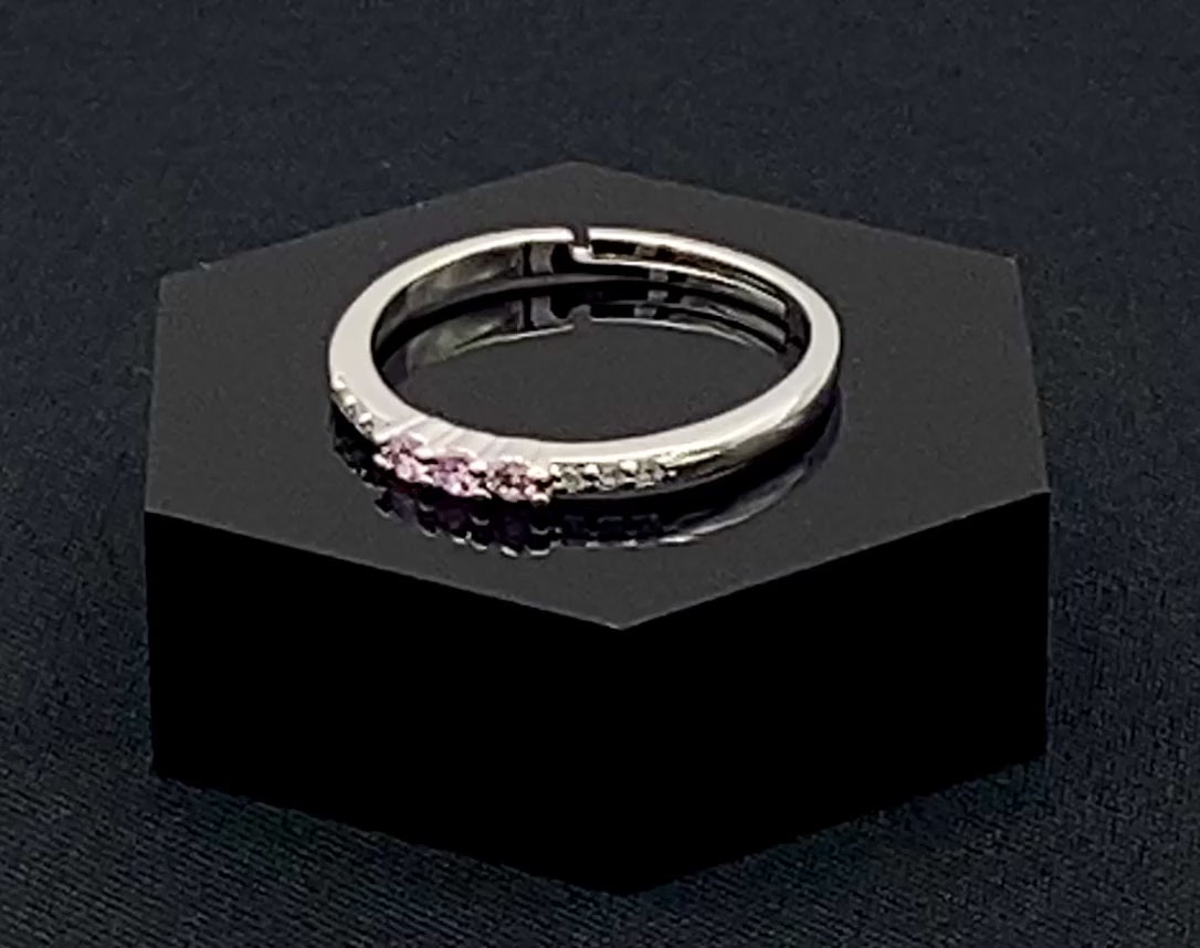 Tanvi Pink Ring: This stunning piece features alternating brilliant blue and clear cubic zirconia stones, set in a sleek silver-plated band. The adjustable fit ensures comfort for any finger size. The ring is non-tarnish and waterproof, maintaining its shine over time. Perfect for everyday wear, the Tanvi ring is your go-to accessory for timeless beauty.