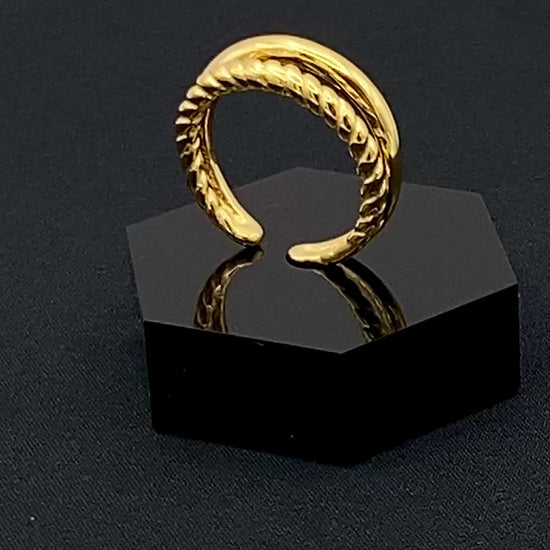 Selene Twin Band Ring Gold: This ring features a unique combination of a textured rope band and a smooth plain band, both gold plated for a luxurious finish. The titanium PVD ensures durability and resistance to wear, while the stainless steel construction adds strength and longevity. The unique twin band design combines elegance and modernity. Available in ring size 7, it is perfect for those who wear this size. Make a statement with this versatile and chic accessory that complements any look.