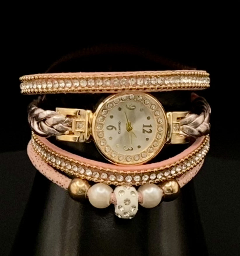 The Melissa Wrist Watch Pink and Gold. Exquisite timepiece with a crystal-studded dial in a sleek alloy case. Luxury quartz movement, genuine leather band, 35mm round case. Adjustable fit with 24cm band length. Non-waterproof. Perfect for charm, fashion, luxury, and antique looks.
