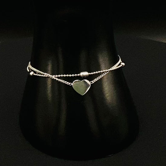 “Cora Twin Chain Heart and Bead Bracelet in gold, featuring a romantic twin chain design with heart and bead accents. silver plated, made from durable titanium steel with PVD plating. Measures 17 cm with a 3 cm extender for adjustable fit.”