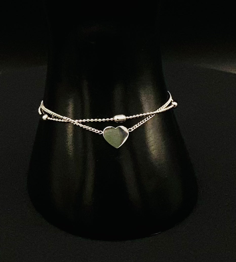 “Cora Twin Chain Heart and Bead Bracelet in gold, featuring a romantic twin chain design with heart and bead accents. silver plated, made from durable titanium steel with PVD plating. Measures 17 cm with a 3 cm extender for adjustable fit.”