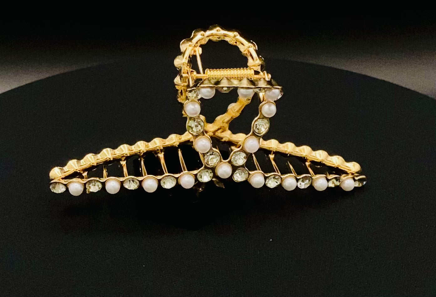 “The Luxe Claw Clip Pearl and Gem Inlay in Gold, crafted from high-quality, durable metal. Measures 11 cm, featuring a luxurious gold finish with beautiful pearl and gem accents. Perfect for securing various hair types and styles, suitable for both everyday wear and special occasions.”
