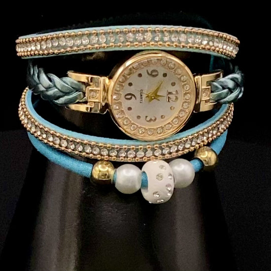 The Melissa Wrist Watch Blue and Gold. Exquisite timepiece with a crystal-studded dial in a sleek alloy case. Luxury quartz movement, genuine leather band, 35mm round case. Adjustable fit with 24cm band length. Non-waterproof. Perfect for charm, fashion, luxury, and antique looks.