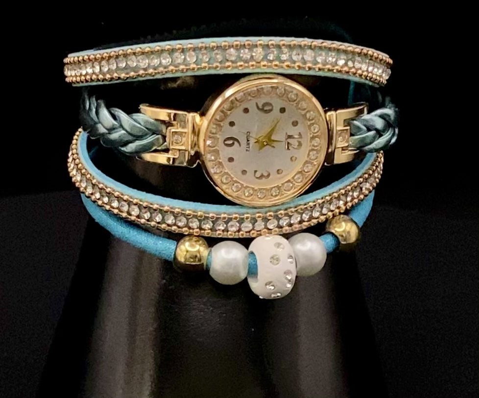 The Melissa Wrist Watch Blue and Gold. Exquisite timepiece with a crystal-studded dial in a sleek alloy case. Luxury quartz movement, genuine leather band, 35mm round case. Adjustable fit with 24cm band length. Non-waterproof. Perfect for charm, fashion, luxury, and antique looks.