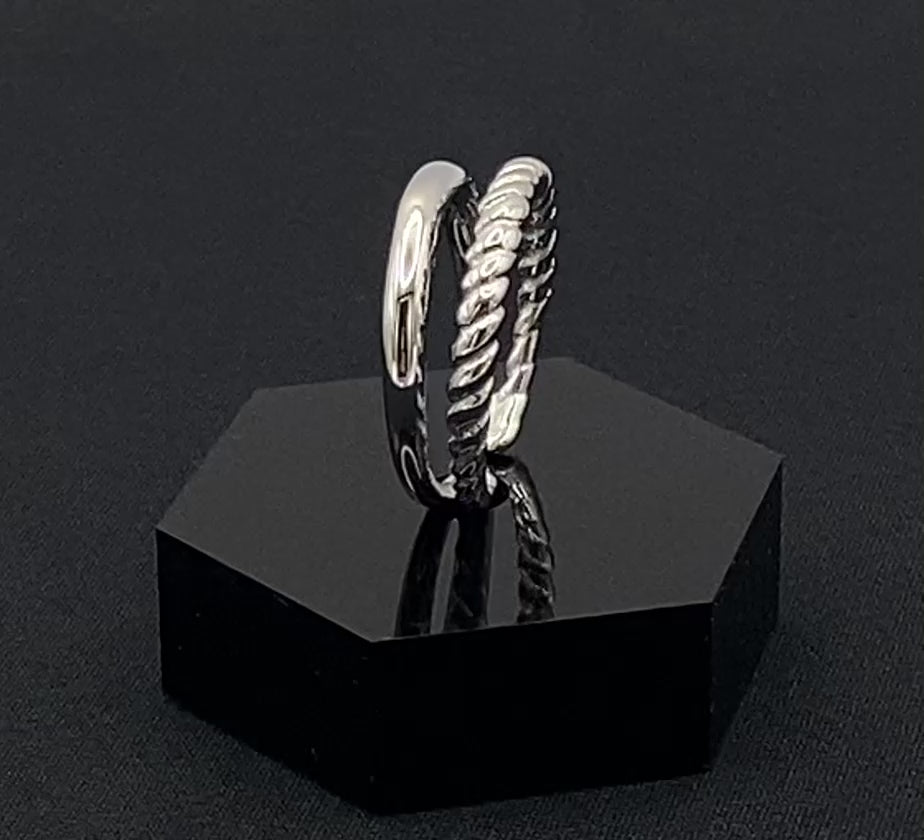 Selene Twin Band Ring Silver: This ring features a unique combination of a textured rope band and a smooth plain band, both gold plated for a luxurious finish. The titanium PVD ensures durability and resistance to wear, while the stainless steel construction adds strength and longevity. The unique twin band design combines elegance and modernity. Available in ring size 7, it is perfect for those who wear this size. Make a statement with this versatile and chic accessory that complements any look.