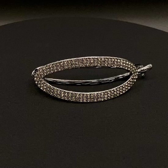“The Missy Hair Clip, crafted from high-quality metal with sparkling zircon inlaid stones. Features a delicate curved design, measures 9 cm in length, and is perfect for securing various hair types and styles. Durable and luxurious, ideal for effortless beauty.”