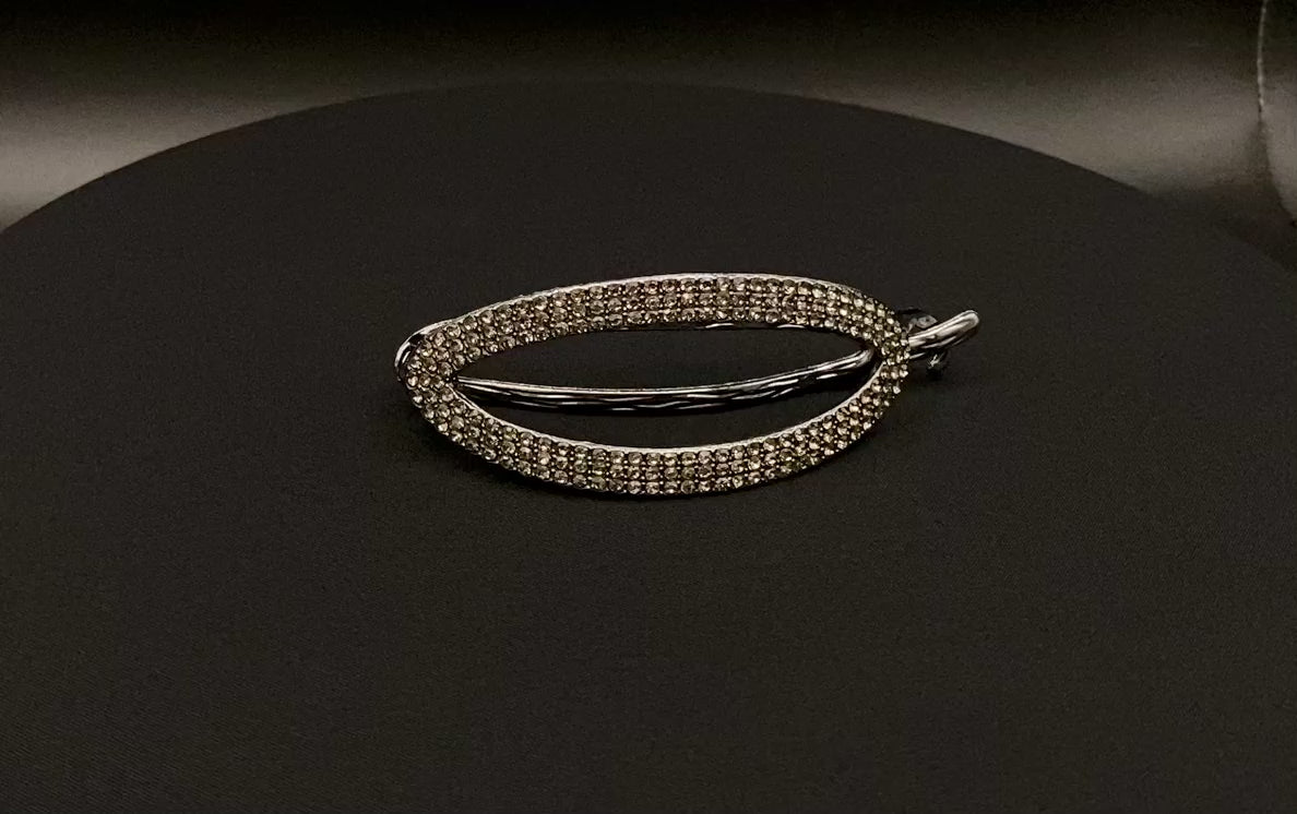 “The Missy Hair Clip, crafted from high-quality metal with sparkling zircon inlaid stones. Features a delicate curved design, measures 9 cm in length, and is perfect for securing various hair types and styles. Durable and luxurious, ideal for effortless beauty.”