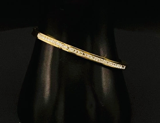 “Simone Encrusted Bangle in gold with 18K gold plating and gemstone inlay, offering a radiant and luxurious finish. Durable construction ensures long-lasting wear and tarnish resistance. Perfect for both everyday wear and special occasions.”