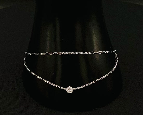 “Aurora Twin Chain Bracelet in silver with a sophisticated twin chain design, adorned with sparkling zirconia gemstones. Waterproof and measures 18 cm with a 3 cm extender for adjustable fit.”