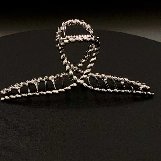 “Bellezza Claw Clip crafted from high-quality acrylic with a dark silver finish. Measures 11.5 cm in length, ideal for securing various hairstyles. Durable and stylish, perfect for both formal and casual occasions.”