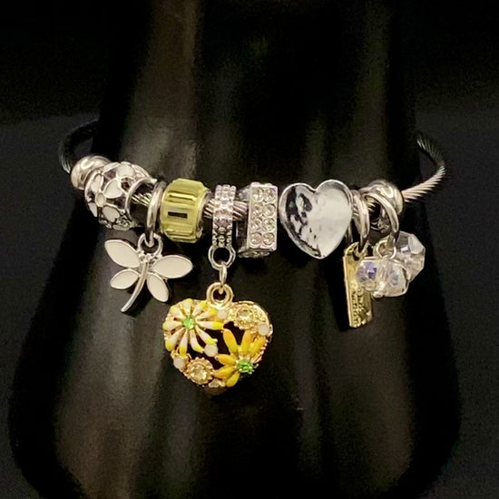 “Stellar Charm Bracelet in yellow with playful charms including a heart, butterfly, and cube, crafted from high-quality stainless steel. Suitable for both women and kids, making it a perfect gift for any occasion.”