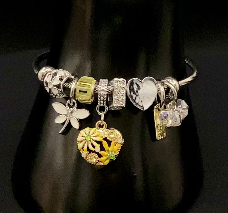 “Stellar Charm Bracelet in yellow with playful charms including a heart, butterfly, and cube, crafted from high-quality stainless steel. Suitable for both women and kids, making it a perfect gift for any occasion.”