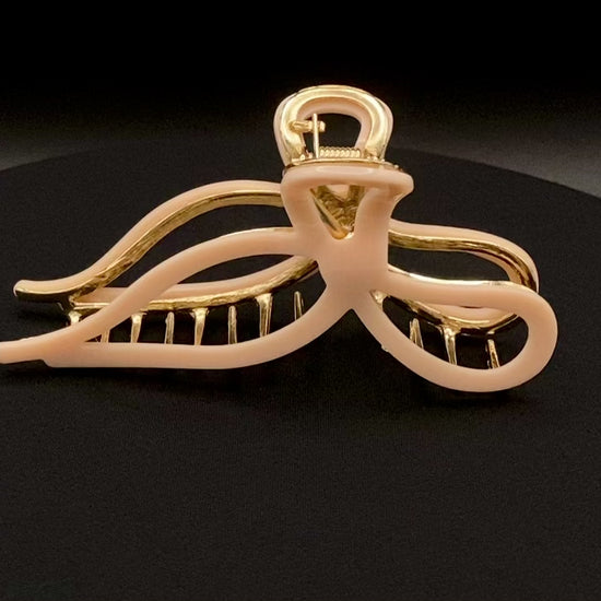  “Anastasia large metal hair claw clip in Pink and gold, perfect for securing thick hair.”