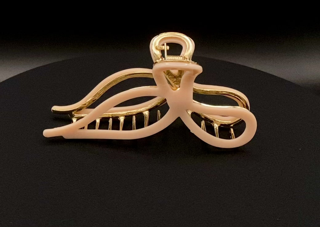  “Anastasia large metal hair claw clip in Pink and gold, perfect for securing thick hair.”