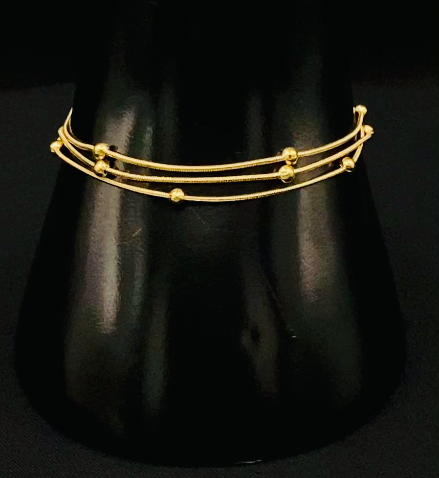 Freya Tri-Chained Bead Bracelet in gold with three delicate chains and evenly spaced small beads. 18K gold plated, made from durable stainless steel with PVD plating. Measures 18 cm with a 3 cm extender for adjustable fit.”