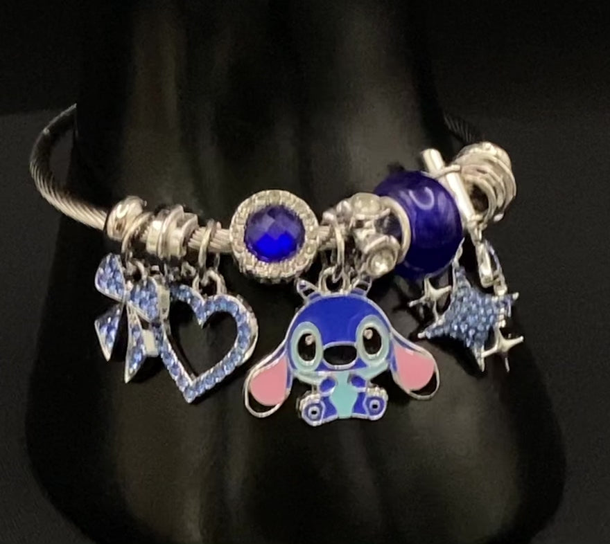 “Cartoon Character Bracelet in Blue with a playful and stylish design, made from durable stainless steel, alloy charms, crystals, and glass beads. Adjustable 6cm diameter for a comfortable fit.”