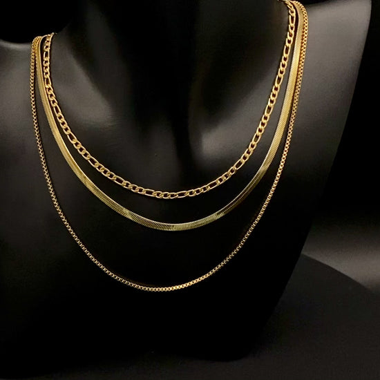 Gina Three Layered Gold Chain Necklace. Three delicate chains layered for a sophisticated look. 18k gold plated, PVD plated for durability. Stainless steel, corrosion-resistant. Adjustable length: 40 cm + 5 cm extender. Versatile for casual and formal wear.