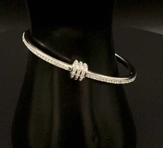 “Eclipse Encrusted Bangle Bracelet in silver with an encrusted gem inlay, featuring silver plating and a thread open and close mechanism for easy adjustment. Made from high-quality materials for long-lasting wear.”