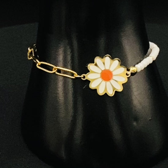 “Daisy Chain Bead Bracelet in white, crafted from stainless steel with 18K gold plating. Features a daisy flower pattern with crystal and rhinestone accents. Eco-friendly, nickel and lead-free, safe for sensitive skin.”