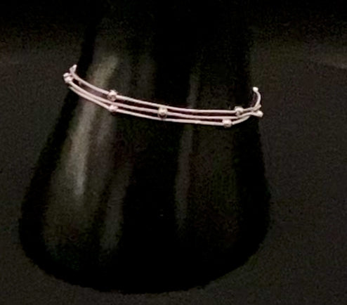 “Freya Tri-Chained Bead Bracelet in silver with three delicate chains and evenly spaced small beads. Silver plated, made from durable stainless steel with PVD plating. Measures 18 cm with a 3 cm extender for adjustable fit.”