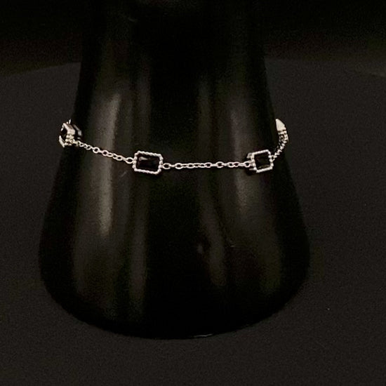 “Clarissa Bracelet in silver with black zircon inset stones, featuring a luxurious silver plating and adjustable length of 17.5 cm with a 2 cm extension. Durable construction ensures long-lasting wear and tarnish resistance.”