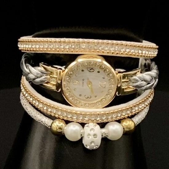 The Melissa Wrist Watch White and Gold. Exquisite timepiece with a crystal-studded dial in a sleek alloy case. Luxury quartz movement, genuine leather band, 35mm round case. Adjustable fit with 24cm band length. Non-waterproof. Perfect for charm, fashion, luxury, and antique looks.