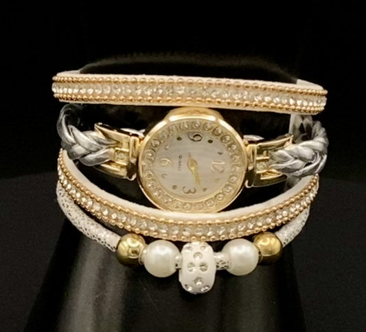 The Melissa Wrist Watch White and Gold. Exquisite timepiece with a crystal-studded dial in a sleek alloy case. Luxury quartz movement, genuine leather band, 35mm round case. Adjustable fit with 24cm band length. Non-waterproof. Perfect for charm, fashion, luxury, and antique looks.