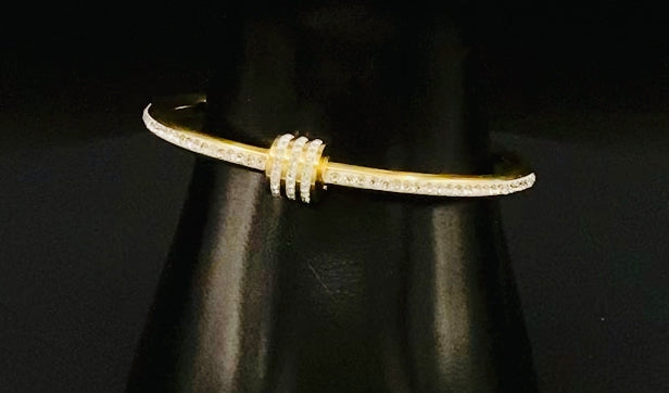 “Eclipse Encrusted Bangle Bracelet in gold with an encrusted gem inlay, featuring 18K gold plating and a thread open and close mechanism for easy adjustment. Made from high-quality materials for long-lasting wear.”