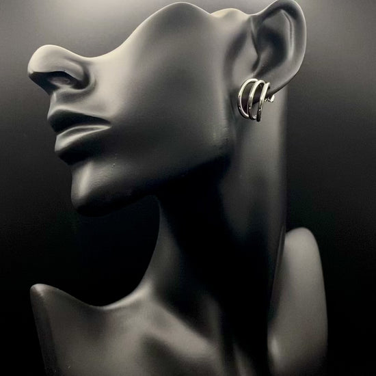 “Trinity 3 Band C Shaped Earrings Silver: A perfect blend of elegance and modern design, featuring sleek silver plating, a unique three-band C shape, and durable stainless steel construction. Ideal for both everyday wear and special occasions.”